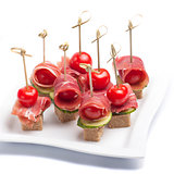 Canapes with tomato and bacon