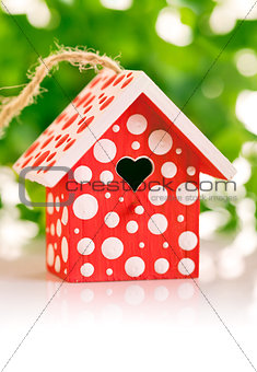 red birdhouse in white polka dot