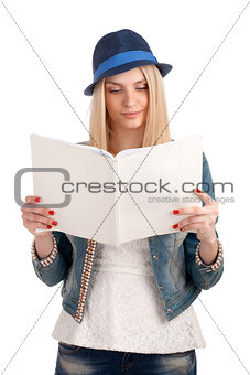 Young woman reading womens magazine