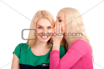 Two women whispering and smiling