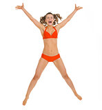 Happy young woman in swimsuit jumping