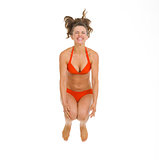Happy young woman in swimsuit jumping in water