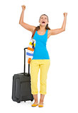 Happy young tourist woman with wheel bag rejoicing