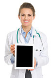 Smiling medical doctor woman showing tablet pc
