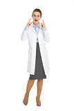 Surprised oculist doctor woman pointing on eyeglasses