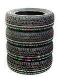 Four new tires stacked on white background