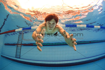 man in swimming pool streching hands