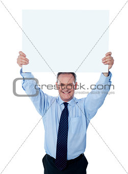 Businessman holding a blank billboard over the head