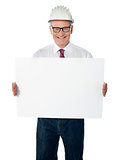 Businessman architect holding a blank white signboard