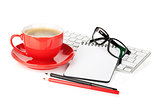 Red coffee cup, glasses and office supplies