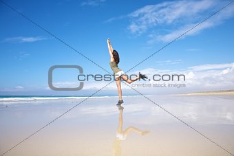 sportswoman stretching on seashore