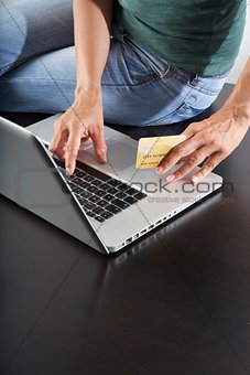 typing in laptop with credit card