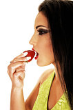 Teen girl eating strawberry.