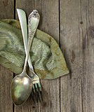 vintage silver cutlery  on a wooden background