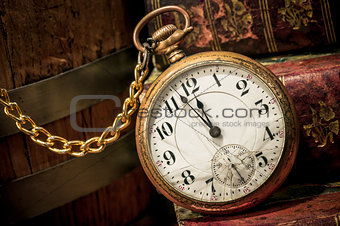 Old pocket watch and books in Low-key