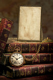 Frame with old photo paper texture, pocket watch and books in Low-key
