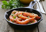 shrimp fried with herbs and spices in a pan