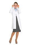 Full length portrait of smiling oculist doctor woman in eyeglass