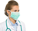 Medical doctor woman in mask looking on copy space