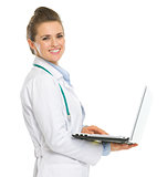 Smiling medical doctor woman with laptop