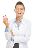 Smiling cosmetologist woman with creme