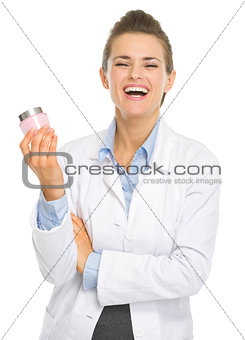 Smiling cosmetologist woman with creme