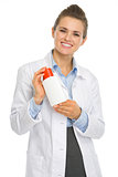 Smiling cosmetologist woman with sun screen creme