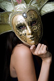 Young woman in a Venetian mask