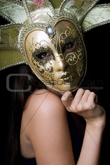 Young woman in a Venetian mask
