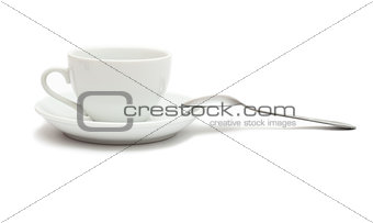 white cup with spoon and saucer