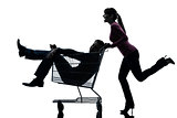 couple woman  with man sitting in shopping cart silhouette