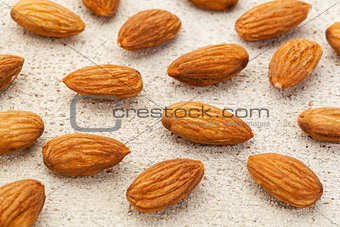 raw almonds on white wood