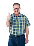 Casual old man showing thumbs-up sign to camera