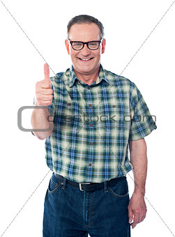 Casual old man showing thumbs-up sign to camera