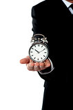 Cropped image of a man with alarm clock on his palm