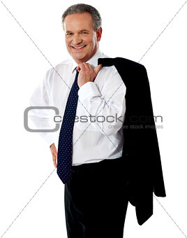 Senior male executive holding coat over his shoulders