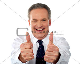 Happy businessman gesturing double thumbs-up