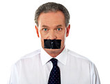 Businessman with taped mouth