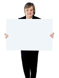 Portrait of a business lady holding a blank billboard