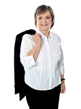 Senior female executive holding coat over her shoulders