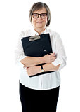 Portrait of senior businesswoman holding reports