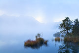 misty morning on alpine lake