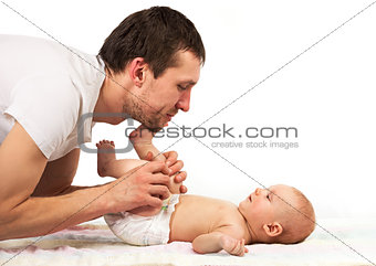 Young Caucasian father playing with baby son