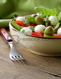 salad with arugula, tomatoes and mozzarella cheese