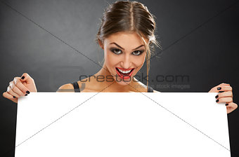 Excited woman holding white billboard