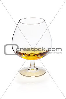 Glass of cognac or whiskey on white