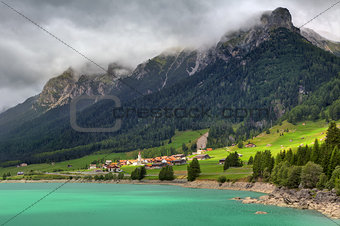 Small village and alpine lake in Switzerland.