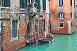 Boat and old brick house in Venice, Italy.