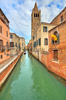 Small canal and typical buildings in Venice, Italy.