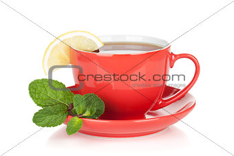 Red tea cup with lemon and mint